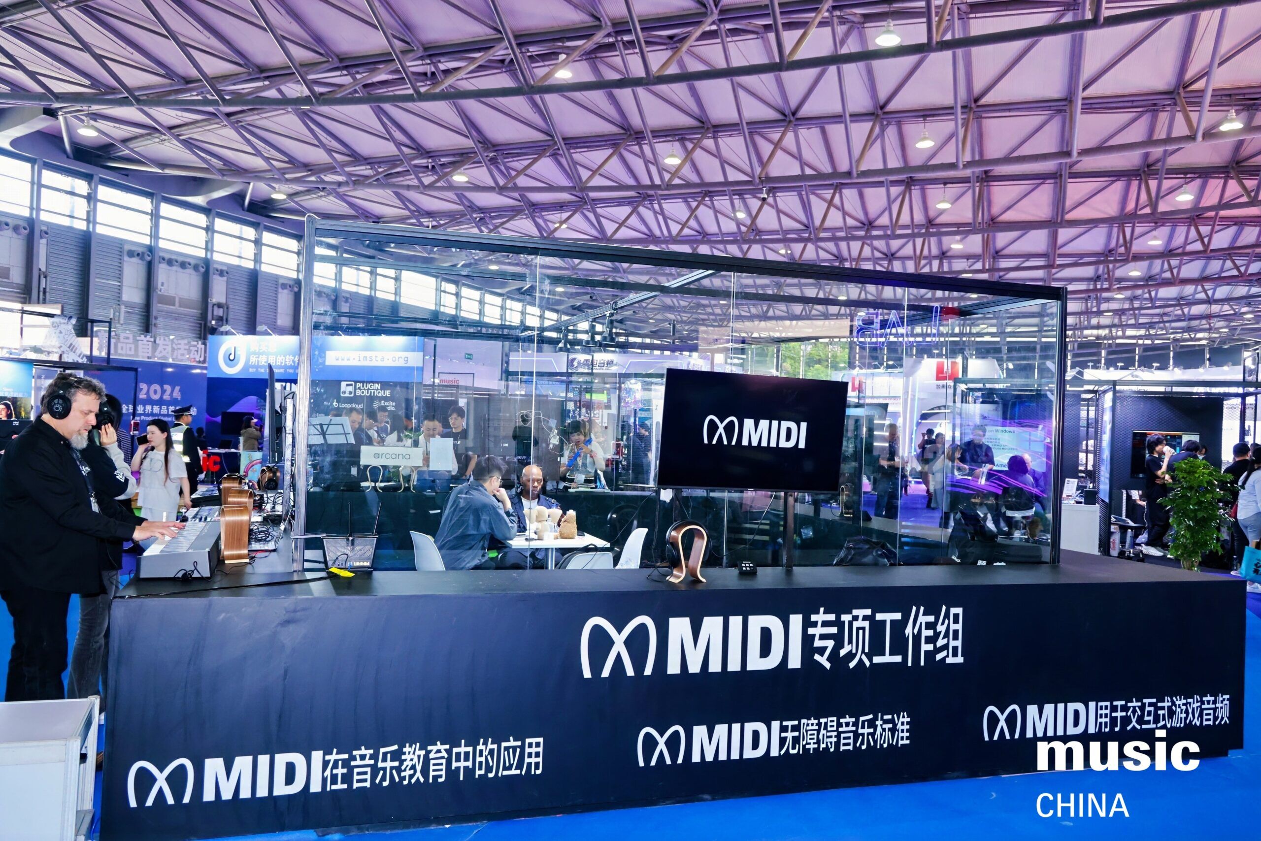 A modern exhibition booth for MIDI at Music China 2024 with glass walls, computers, and people working and conversing. White MIDI logos and Chinese text are displayed on the front of the booth.