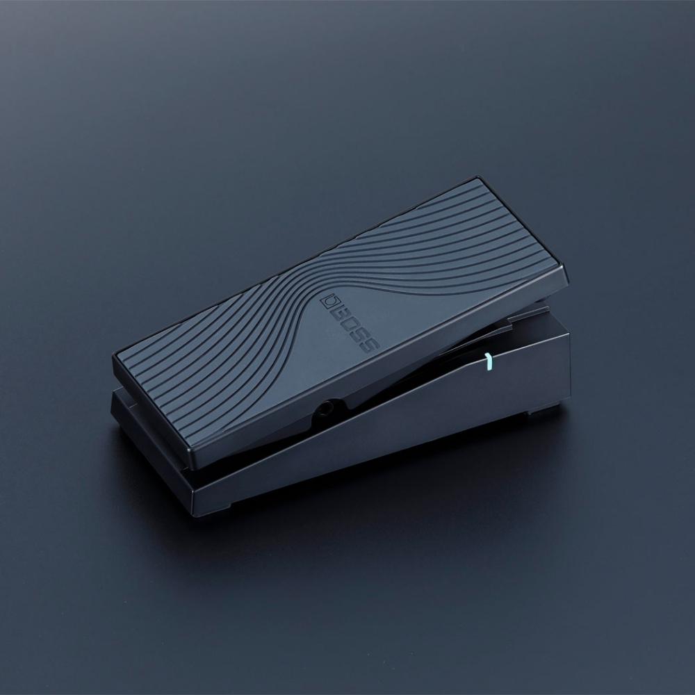 A black Boss expression pedal with a textured, wave-like pattern on its surface, displayed on a dark grey background.