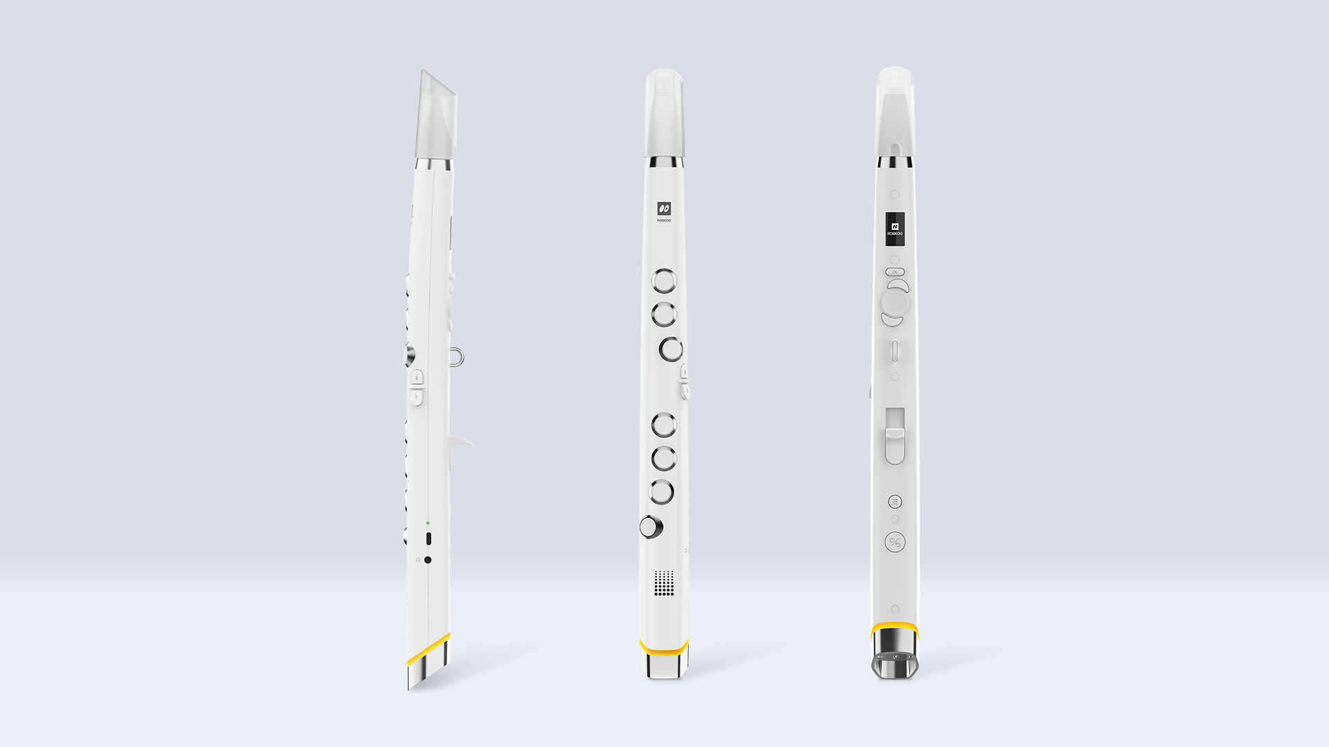 Three sleek, white, electronic wind instruments are displayed upright against a light grey background, each showing different angles and button configurations, with yellow accents near the bottom.