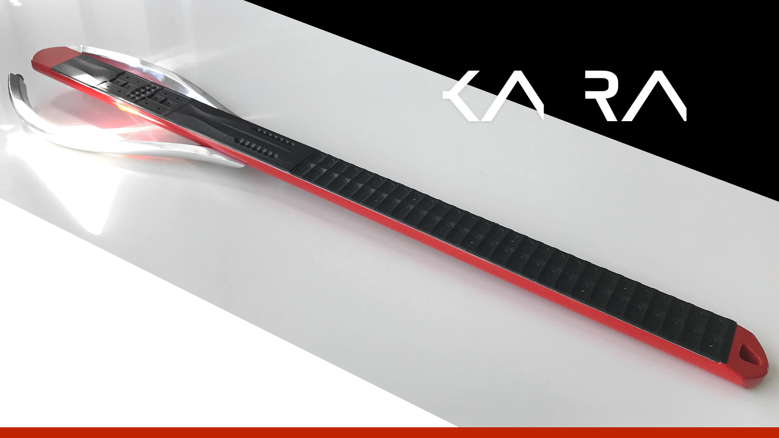 A sleek, red and black electronic instrument resembling a futuristic guitar lies on a white surface. The brand name KARA appears in stylized white letters on a black background in the corner.