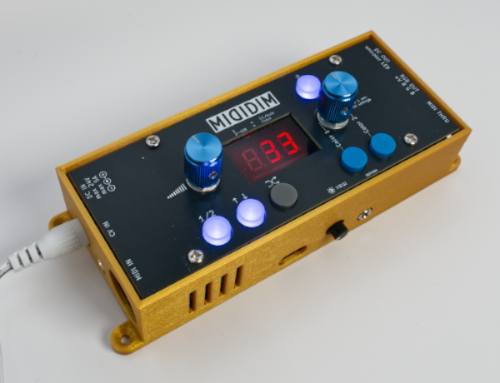 A compact electronic MIDI controller with a gold casing, blue knobs, white buttons, a red digital display showing 33, and labeled MIDIDIM on the front panel.