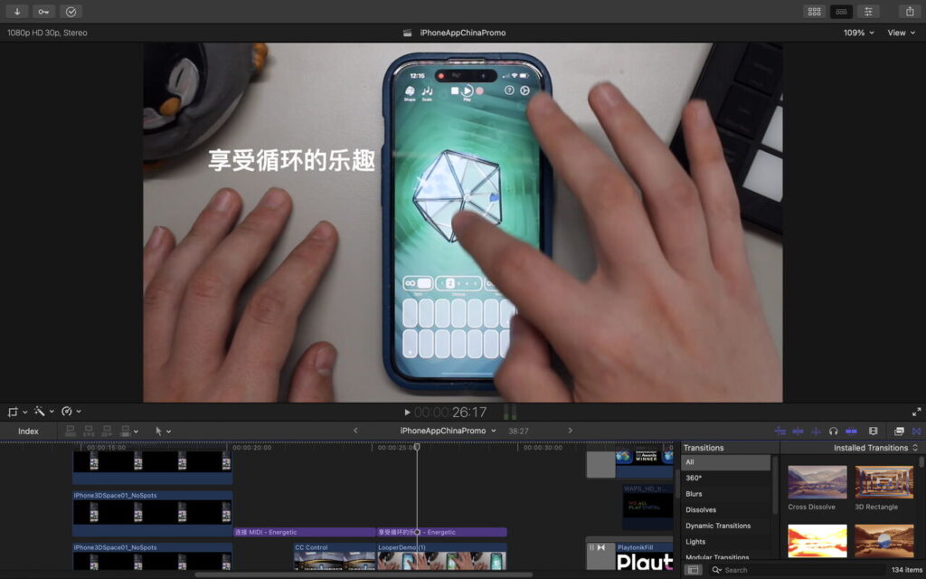 A person uses a smartphone with a music app open, shown editing a video on a computer screen. Chinese text appears on the phone screen, and editing software timelines are visible.
