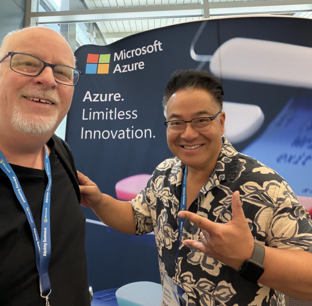 Two smiling people stand in front of a Microsoft Azure banner that says Azure. Limitless Innovation. Both wear badges and lanyards, and one person is making a peace sign with his hand.