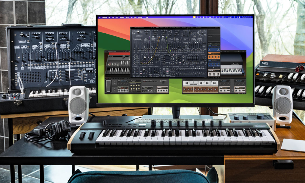 A home music studio with a large monitor showing digital synthesizers, a keyboard controller, speakers, cables, and vintage synthesizer equipment on a desk near a window.